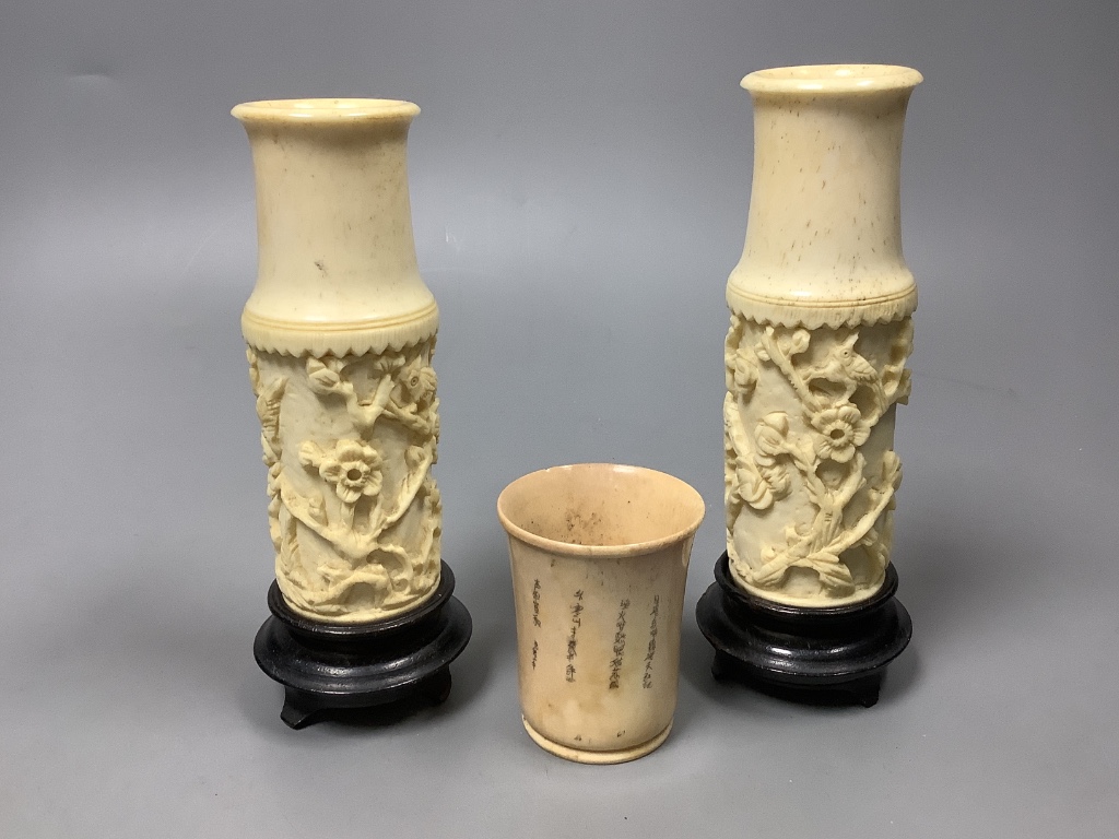 A Chinese engraved bone bead necklace, a pair of engraved bone vases on stands and an engraved bone dice shaker